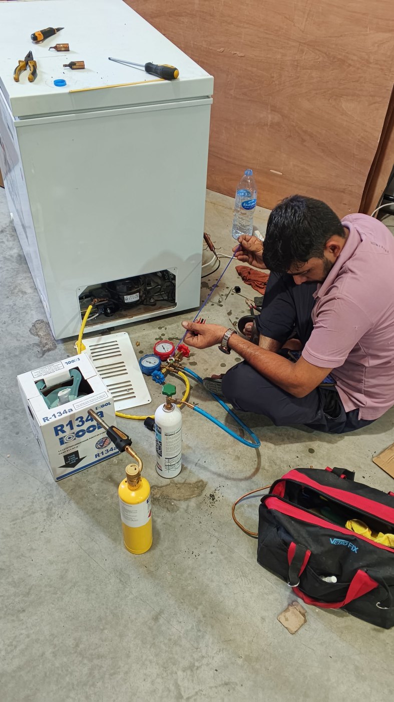 Recharging a chest freezer with R-134a refrigerant gas in Dubai